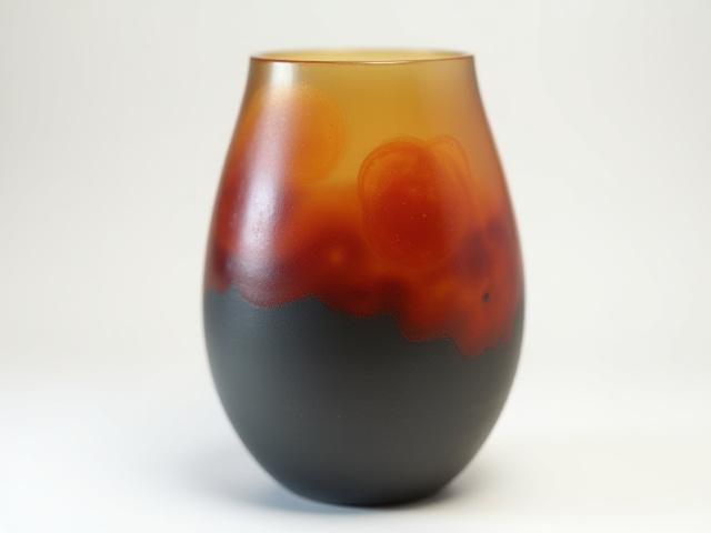 Hand-thrown ceramic vase with vibrant red, orange, and charcoal glass inlay, 'Prairie Fire' series.