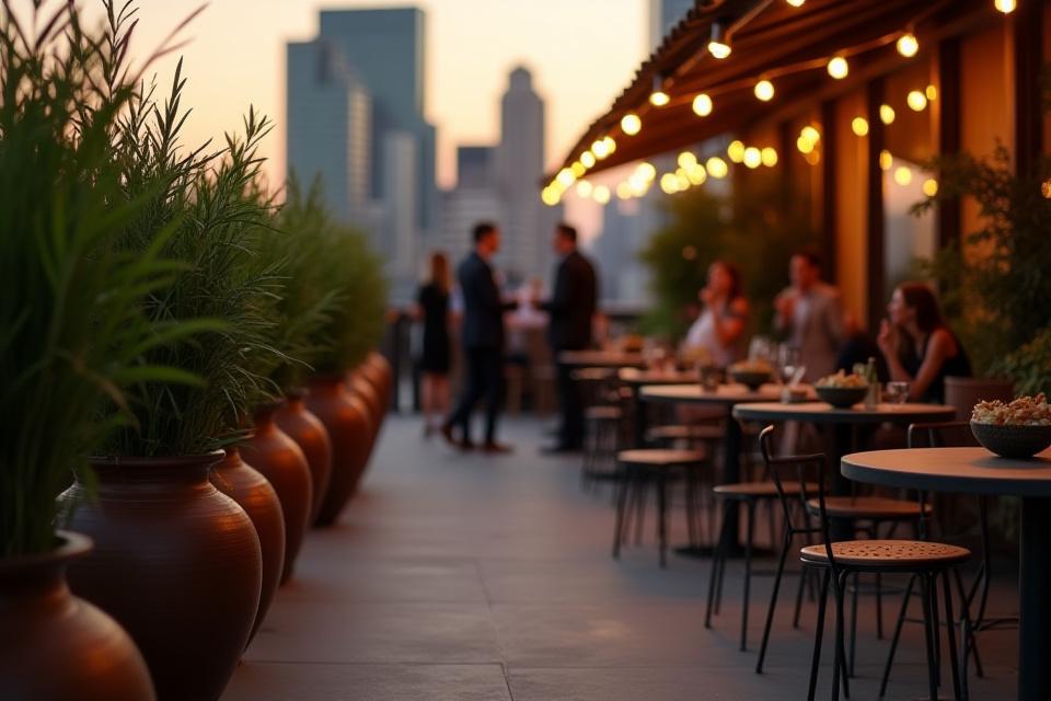 Custom planters and serving bowls from Cast & Clay on a chic rooftop bar patio at The Veridian Hotel, bustling with patrons