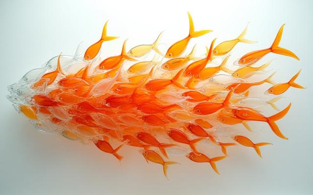A dynamic cluster of hand-blown glass fish in various sizes and colors, creating a vibrant focal point.
