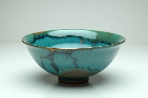 Hand-thrown ceramic bowl with swirling blue glaze
